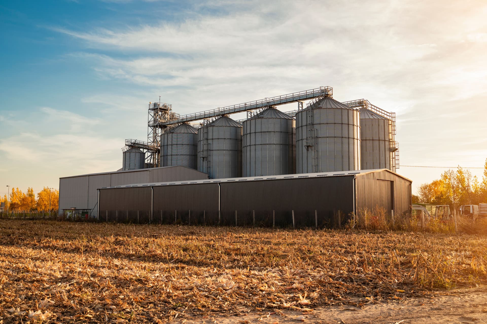 Grain silos and metal barn after farm input loans standing strong on a Midwestern farm