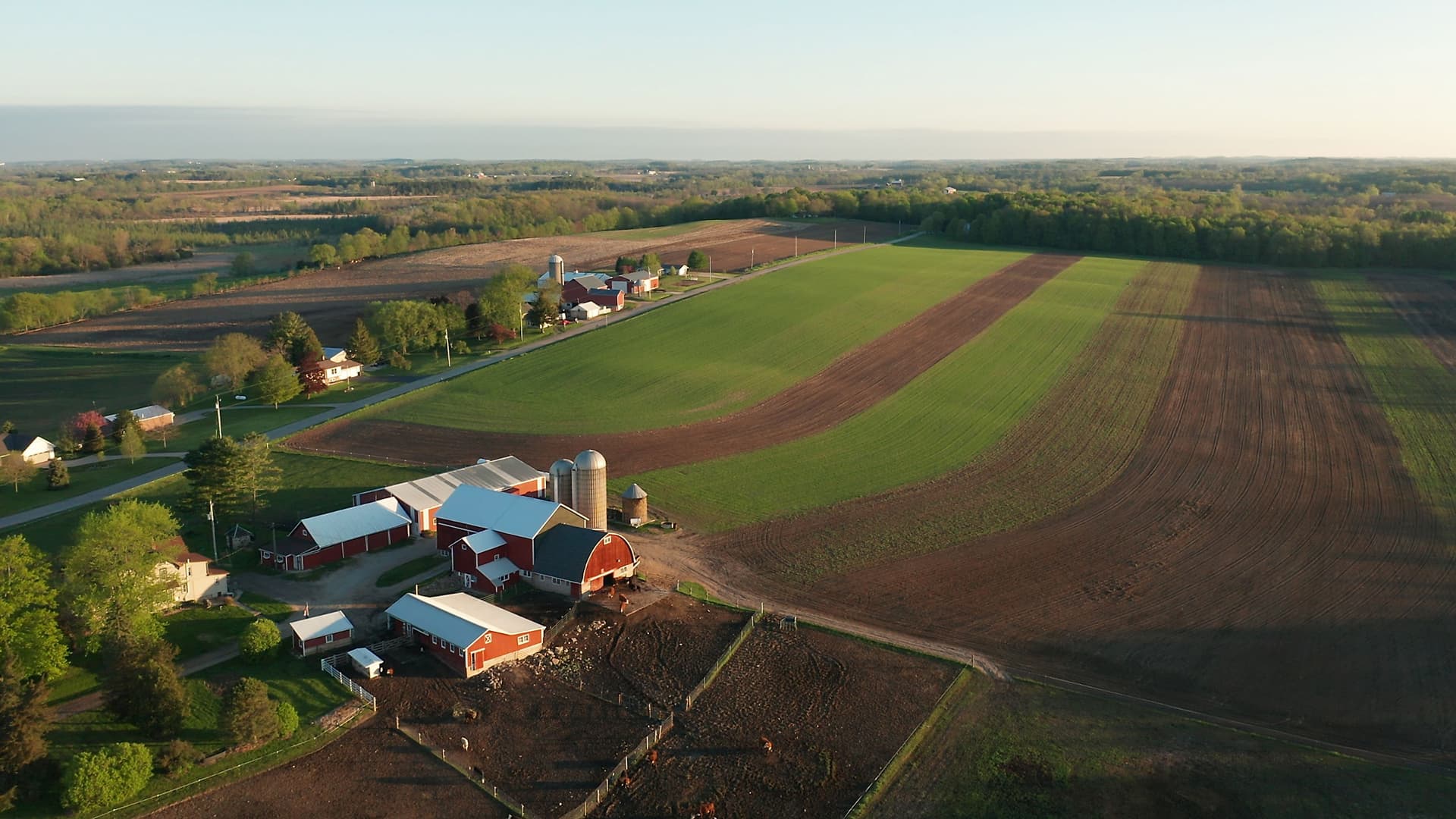 Aerial view of farmland and barns representing strategic farm financing for expansion